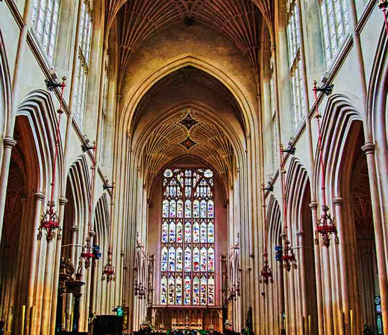 Bath Abbey interior Large stained glass window and fan vaulted ceiling.