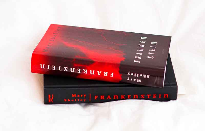 Mary Shelley book Copy of Frankenstein, red cover design with lightning.