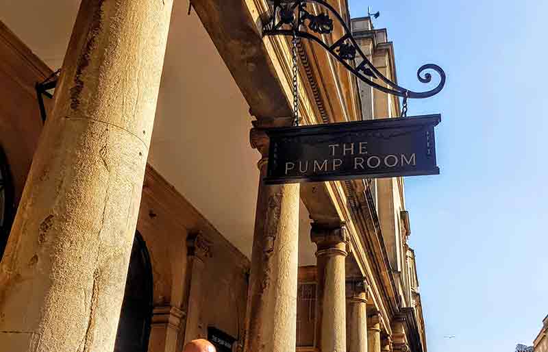 The Pump Room exterior Stone columns and ornate iron sign.